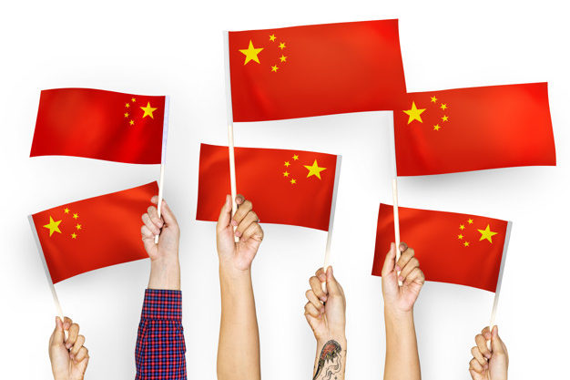 Hands waving flags of China